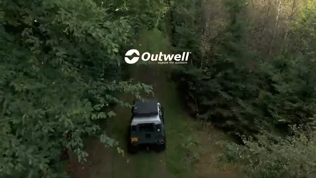 Outwell rooftop tent being prepared for camping in woodland